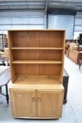 An Ercol dresser of narrow proportions with shepherds castors, dimensions approx. W91 D44 H162cm
