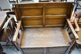 A mid 20th Century oak monks seat of typical design , width approx. 107cm