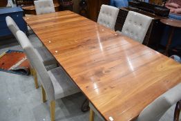A modern hardwood extending dining table on metal work frame