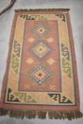 A vintage rug in the aztec style design