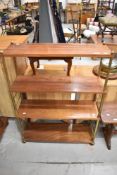 A mid century shelf unit with brass frame and Mahogany shelves.
