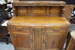 A 1940's oak court cupboard form sideboard, with carved and moulded detail 133cm x 132cm