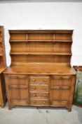 A traditional dark stained Ercol or similar kitchen dresser