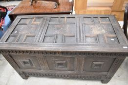 A 17th Century and later oak kist in the Jacobean style having typical cushioned panelling and later