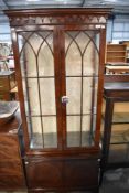 A modern display case with astral glazed doors and under cupboard. 186cm H x 80cm W