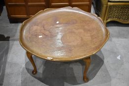 A mid 20th Century coffee table having scallop bowled top on cabriole legs
