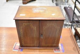 An Edwardian mahogany smokers cabinet having inlaid decoration