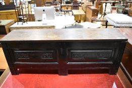 A traditional hardwood bedding box of small proportions having carved decoration to panels, width