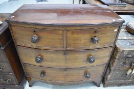 A Victorian bow fronted chest of two over two drawers with cock beaded draw fronts and original