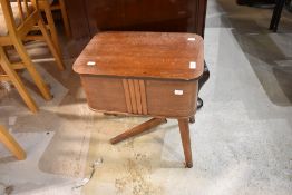 A mid century sewing box with cantilever lid.