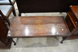 A reproduction mahogany coffee table, of oblong form with cabriole type legs