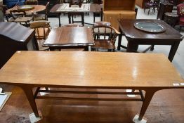 A mid century Teak coffee table with under shelf