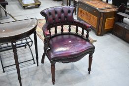 A reproduction carver chair having oxblood leather upholstery