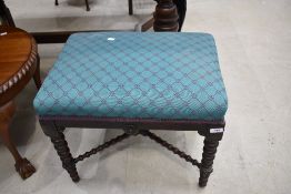 A Victorian dressing table stool on a bobbin turned framed with cross brace