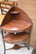 A 19th Century mahogany corner washstand, having central frieze drawer flanked by two dummies