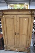 A reclaimed pine armoire or double door wardrobe,of inverted breakfront form with reeded columns,