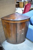 A 19th Century mahogany bow front corner cupboard