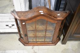 A modern oak wall mounted display cabinet , ideal for toy cars, thimbles or other small decorative