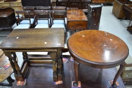 A 1930's circular walnut occasional table, sold along with a nest of two oak occasional tables