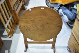 A traditional oak Arts and Crafts folding table having circular top, in very clean condition