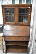 An oak bureau book case with leaded light style doors and oak frame.