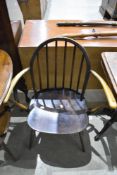 A dark stained Ercol carver chair