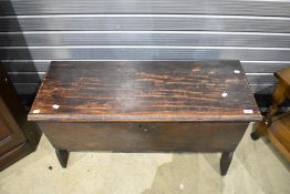 An 18th century oak plank coffer, of oblong form, the lift up top with incised linear and dog