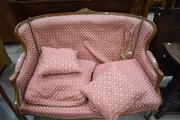 A French Louis XV style settee, having carved and moulded show frame and patterned material