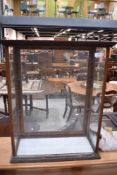 An early 20th century glazed display cabinet, with glass shelving