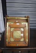 A Victorian brass-mounted oak coal scuttle, having turned brass carrying handle over the sloped