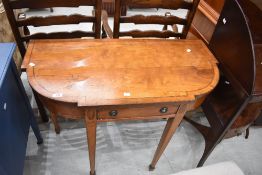 An early 20th Century Regency revival side table having line inlay decoration, frieze drawer and
