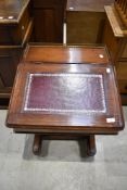 A late 19th century walnut Davenport, having brass three quarter gallery, stained leather skiver and