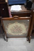 An mahogany and tapestry fire screen with integral handle to top rail 79cm