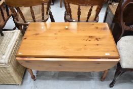 A modern pine drop leaf coffee table