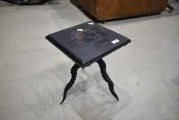 An edwardian stained oak occasional table, the square moulded top raised on three twisted antelope