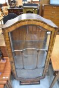 An Edwardian display case having Walnut veneer with astral glazed door.