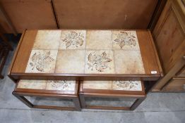 A nest of three 'Sunelm' tile-topped occasional tables, comprising large coffee table and two