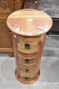 A modern imported wood cylindrical chest of four drawers, each drawer with metal fitments, 83cm