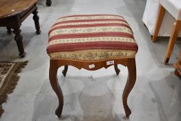 An early 20th century piano stool with cabriole legs and shaped frame.