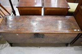 A late 18th century primitive English Oak coffer with plain plank top and sides having poker work