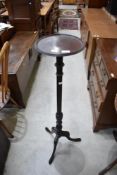 A Victorian torchere stand on a Mahogany frame with tripod base.