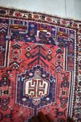 A Persian Qashgai type rug, having central pole medallion within a ground of stylised motifs and