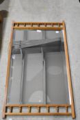 A lightwood wall mirror having spindle decoration to frame