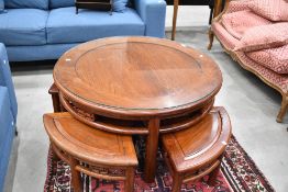 An Oriental hardwood coffee table nest