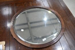 A circular wall mirror (ex dressing table)