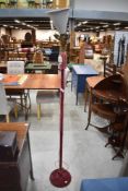 A 1930's Art Deco material covered standard lamp, having four electrical fittings over the pink