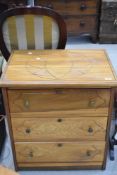 An Oriental style three drawer chest , on castors, with geometric pattern to top