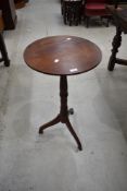 An early 20th century wine table having Mahogany frame on turned support and tripod base.