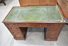 A late 19th or early 20th Century mahogany pedestal desk , in the Regency design