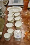 Fifteen Royal Doulton Paisley pattern tea cups with a sugar bowl and serving dish.